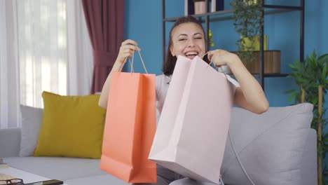Young-woman-looking-at-camera-with-shopping-bags.